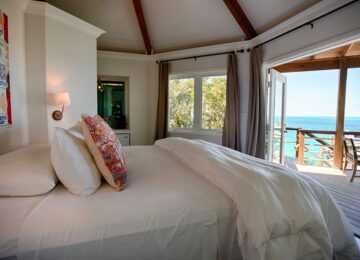 a-bed-in-a-bedroom-at-the-staniel-cay-yacht-club-with-a-view-of-the-ocean